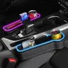 Car seat crevice storage box with dual USB charger, colorful LED light, and compartments for phone, cup, and cards